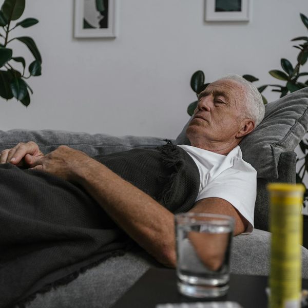 Person meditating peacefully in a bright, sunlit room.